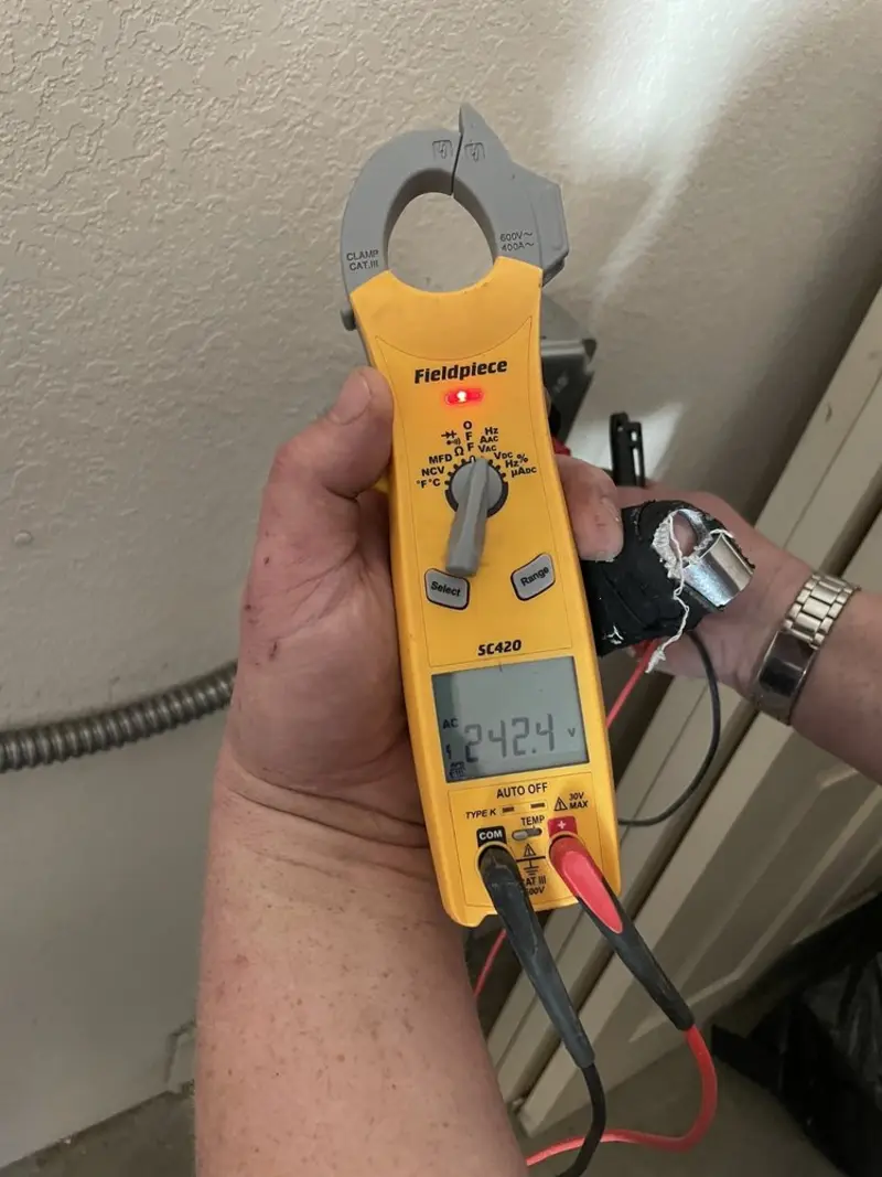 Voltage testing with clamp meter during Electrical Installation Services in Reading